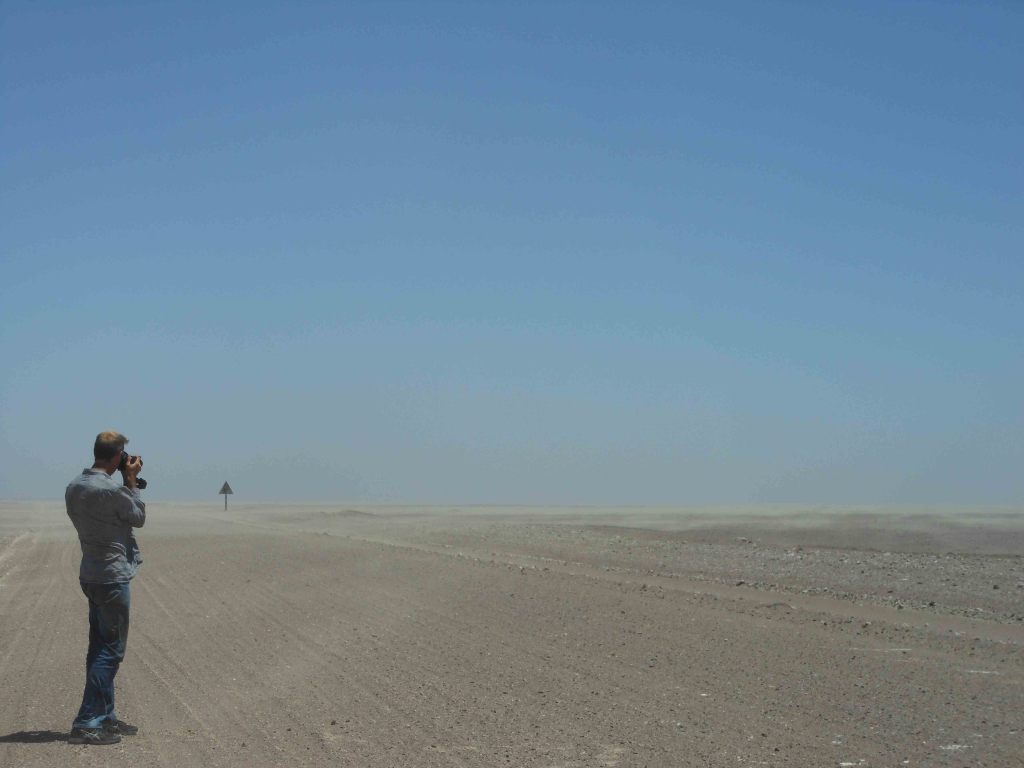 Jonathan trying to take pictures of the sand moving in the wind